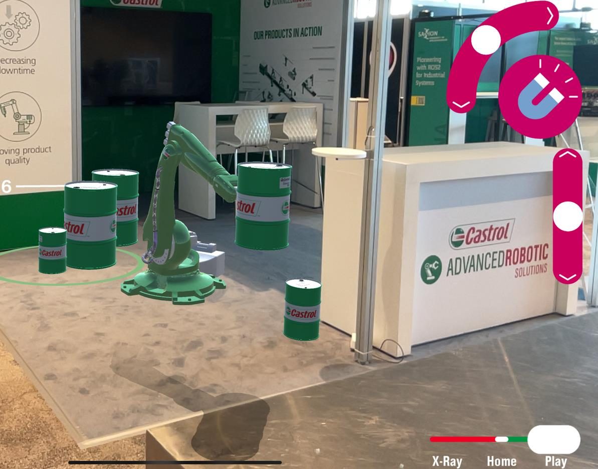 Castrol Robot AR showing a green six-axis robot arm on the stand floor with X-ray controls