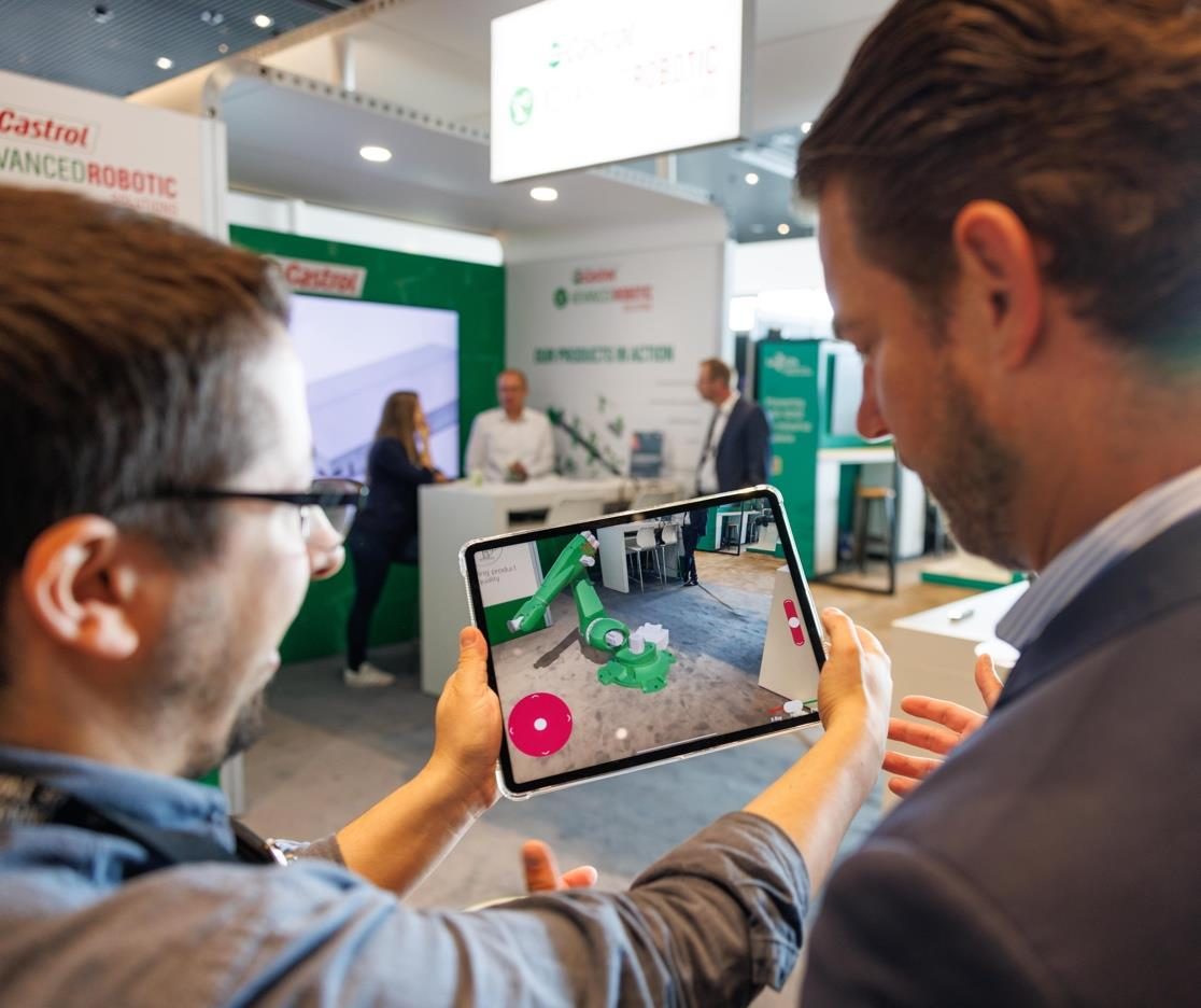 Visitors using the Castrol Robot AR app on an iPad at the Castrol Advanced Robotic Solutions stand