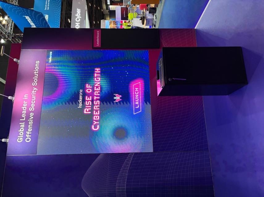 HackerOne Rise of Cyberstrength game on a large stand screen with a plinth controller
